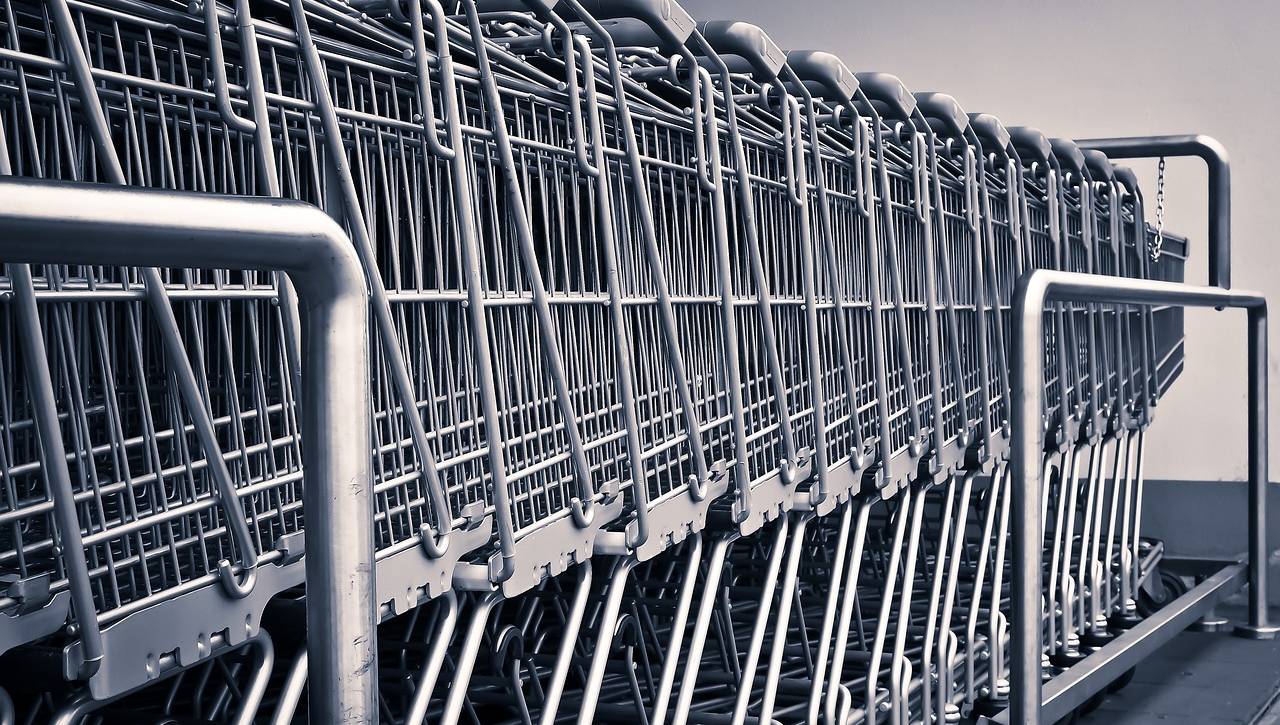 Row of shopping carts symbolizing retail operations, inventory management, and aligning customer experience through strategic consulting with xCanary