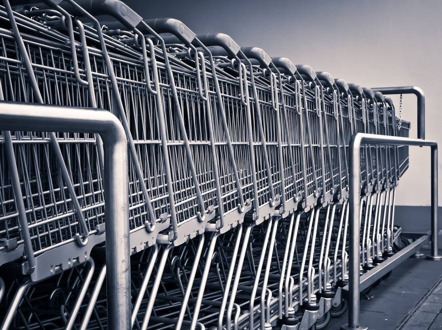 Row of shopping carts symbolizing retail operations, inventory management, and aligning customer experience through strategic consulting with xCanary